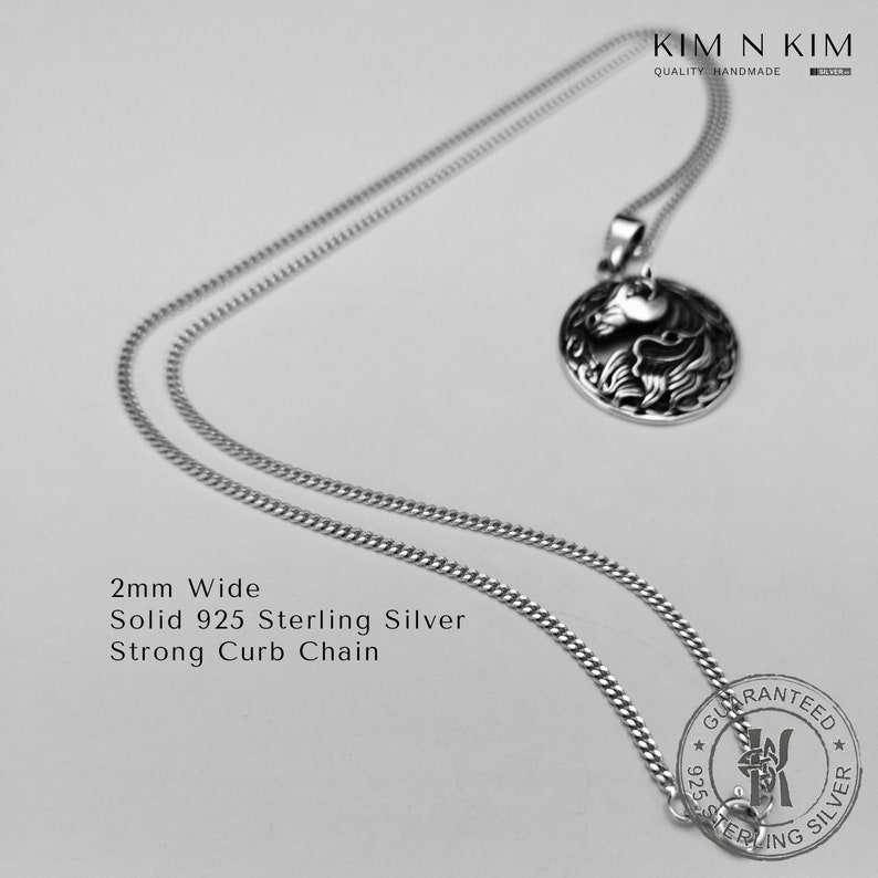 May include: A silver chain necklace with a 2mm wide curb chain and a round pendant with a detailed design. The pendant is made of solid 925 sterling silver. The chain and pendant are guaranteed to be sterling silver.