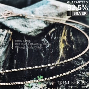 May include: A silver curb chain necklace, 2mm wide, made of 925 solid sterling silver. The chain is shown on a camouflage background. The text "GUARANTEED 92.5% SILVER" is visible in the top right corner of the image. The text "KIM N KIM QUALITY HANDMADE SILVER" is visible in the bottom right corner of the image.