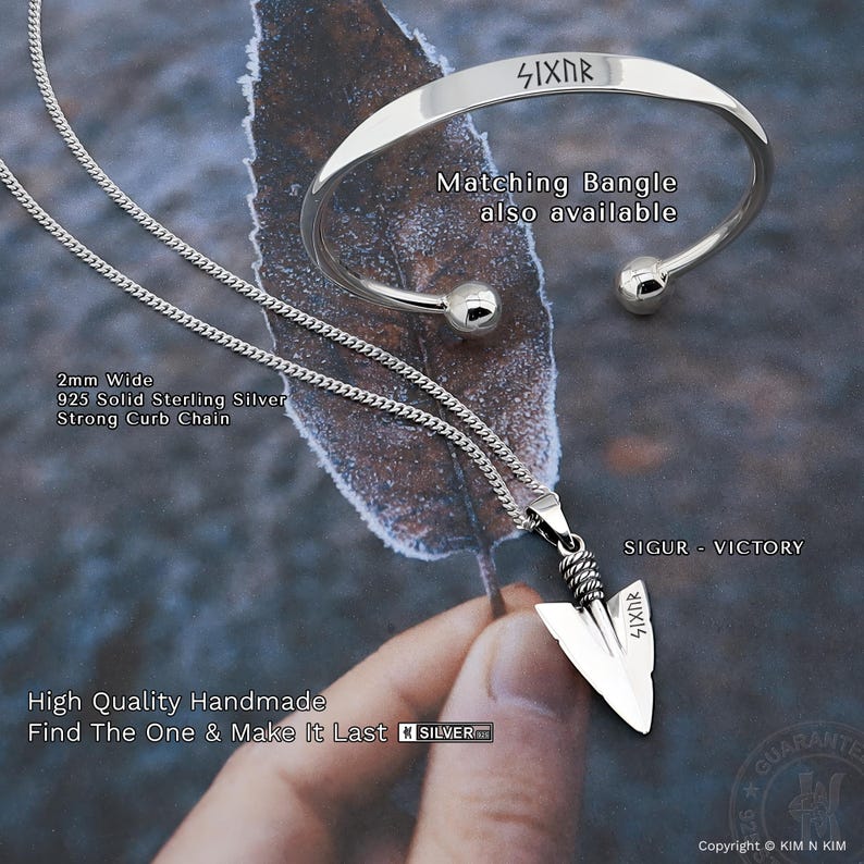 May include: A 925 sterling silver curb chain necklace with an arrowhead pendant engraved with the text SIXNR and a matching open bangle bracelet also engraved with SIXNR. The jewelry features a polished finish and a 2mm wide chain design.