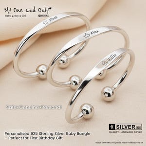 May include: Three sterling silver baby bangles with personalized names: Noah, Alex, and Ellie. Each bangle features a smooth, curved design with a small ball at each end. The text "My One and Only" is at the top.