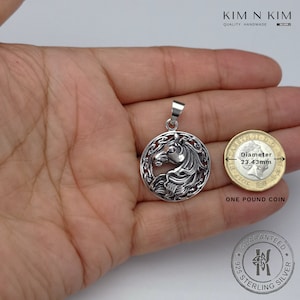 May include: Sterling silver Celtic horse pendant with a detailed design. The pendant is 23.43 mm in diameter and is shown next to a one pound coin for size comparison.  Guaranteed 925 Sterling Silver.