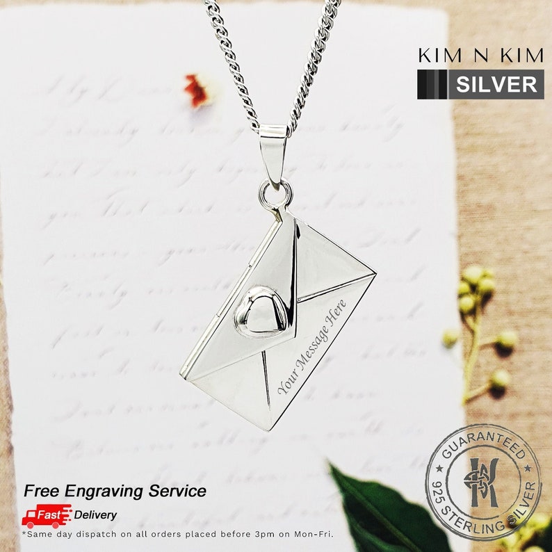 May include: Silver necklace with a sterling silver envelope pendant. The pendant has a heart detail and the words "Your Message Here" engraved on it. The necklace is guaranteed to be 925 sterling silver.
