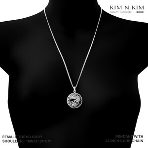 May include: Silver necklace with a round pendant featuring a detailed horse design. The chain is 22 inches long and the pendant is 16 inches from the shoulder.