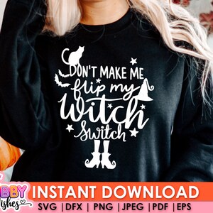 以下が含まれることがあります： 「Don't make me flip my witch switch」と書かれた白いグラフィックデザインが施された黒いスウェットシャツ。グラフィックには、黒い猫、魔女の帽子、星も含まれています。