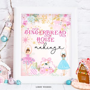 May include: A pink and blue printable sign with the text "Gingerbread House Making" and illustrations of two ballerinas, one in pink and one in blue, with a gingerbread house in the background.