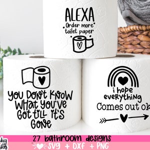 May include: Three white toilet paper rolls with black text and illustrations. The top roll says "Alexa Order more toilet paper" with a small heart and toilet paper roll illustration. The middle roll says "You don't know what you've got till it's gone". The bottom roll says "I hope everything comes out ok" with a rainbow and arrow illustration.