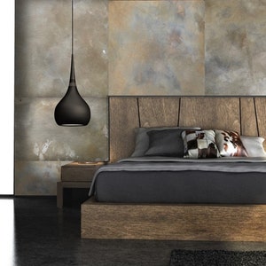 May include: A modern bedroom with a wooden bed frame, a grey duvet, and two black pendant lights hanging from the ceiling. The bedroom has a wooden dresser and bedside tables.