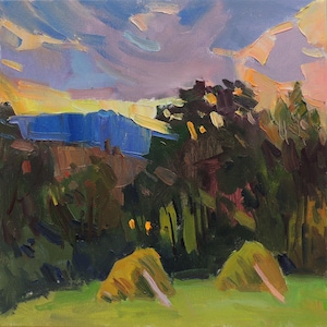 May include: An oil painting on canvas depicting a landscape with two haystacks in a green field. Dark green trees stand before a distant blue mountain range under a sky filled with purple, orange, and yellow clouds, rendered with visible brushstrokes.
