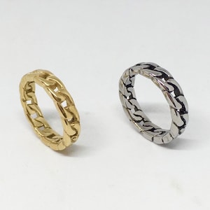 May include: Two chain link rings, one gold and one silver.