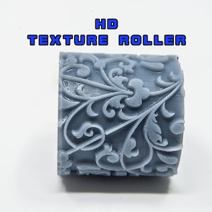 May include: A gray textured roller with a floral design. The roller is labeled "HD TEXTURE ROLLER".