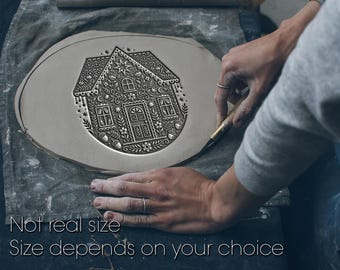 May include: A detailed, gray ceramic plate with an embossed gingerbread house design. The house features intricate floral and star patterns, windows, and a door. The text "Not real size, Size depends on your choice" is at the bottom.