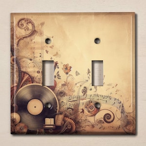 May include: A vintage-style light switch cover with a musical theme. The design features a vinyl record, musical notes, and a floral motif on a beige background.