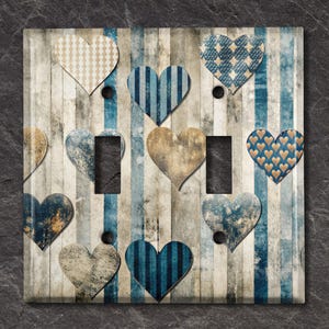 May include: Light switch cover with a distressed wood background and a pattern of blue and beige hearts. The hearts have different patterns, including stripes, polka dots, and a floral design.