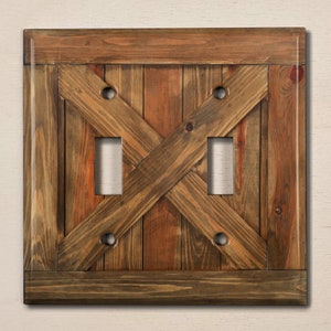 May include: A rustic wooden light switch cover with a distressed brown finish and a criss-cross pattern. The cover has two switch openings.