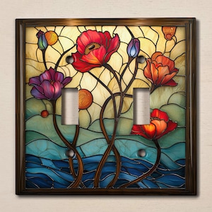 May include: A stained glass light switch cover featuring a floral design with red, purple, and blue flowers on a blue and green background.