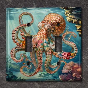 May include: A light blue and teal background with a colorful octopus with pink, orange, and yellow accents. The octopus is surrounded by coral and flowers. The image is for a light switch cover.