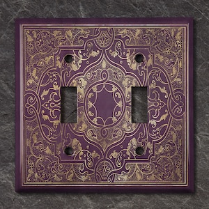 May include: Purple double light switch cover with a gold ornate design.