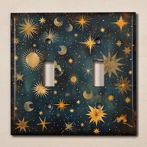 May include: A decorative light switch cover featuring a celestial design with gold stars, moons, and suns on a dark blue background.