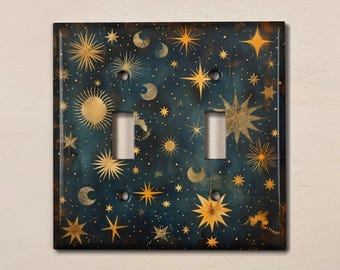 May include: A decorative light switch cover featuring a celestial design with gold stars, moons, and suns on a dark blue background.