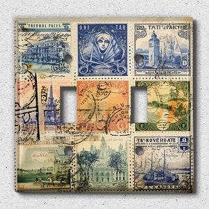 May include: A light switch cover with a collage of vintage postage stamps featuring images of buildings, a woman in a blue robe, a lighthouse, and a ship. The stamps are in various colors, including blue, red, green, and yellow.