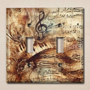 May include: A light brown, beige, and cream light switch cover with a vintage musical design. The design features a treble clef, piano keys, and musical notes.