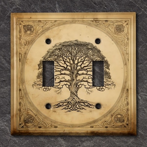 May include: A light switch cover with a decorative design of a tree with intricate roots and branches. The cover is made of a light brown material and has a Celtic knot border.