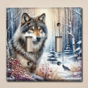 May include: A double light switch cover featuring a watercolor painting of a wolf in a snowy forest. The wolf is looking to the right, and there are trees and snow in the background.
