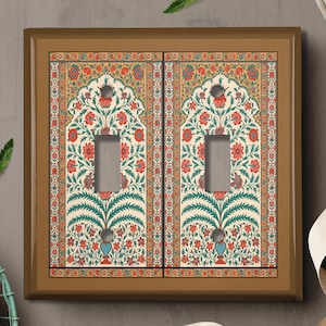 May include: A brown light switch cover with a decorative design featuring a floral pattern in shades of red, green, and blue. The design is reminiscent of traditional Indian or Persian art.