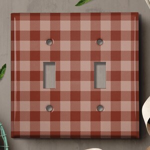May include: A red and white checkered light switch cover. The cover has a rustic, farmhouse style.
