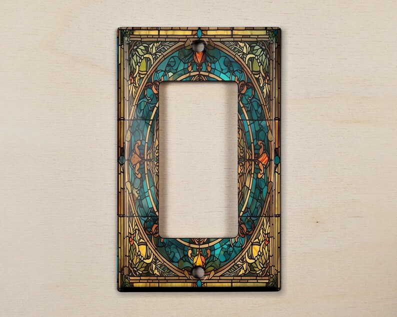 May include: A decorative light switch cover with a stained glass design featuring a circular pattern of blue, green, yellow, and orange colors.