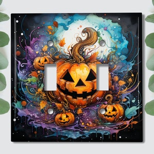 May include: A black light switch cover with a colorful, abstract design featuring three jack-o'-lantern pumpkins. The pumpkins are orange and have carved faces. The background is a mix of blue, purple, and green colors with splatters of paint.