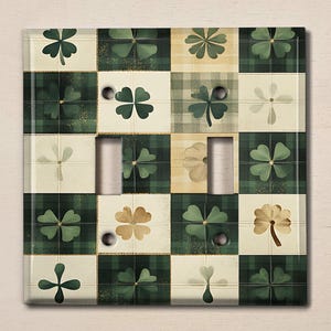 May include: A light switch cover with a green and white checkered pattern featuring four-leaf clover designs.