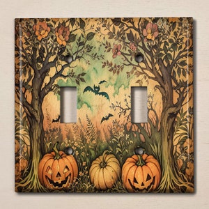 May include: A light switch cover with a Halloween theme. The design features two trees with orange pumpkins and bats flying in a forest setting.