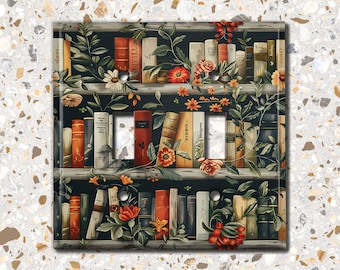 May include: A light switch cover featuring a design of a bookshelf filled with books and flowers. The books are in various colours and sizes, and the flowers are in shades of red, pink, and white.