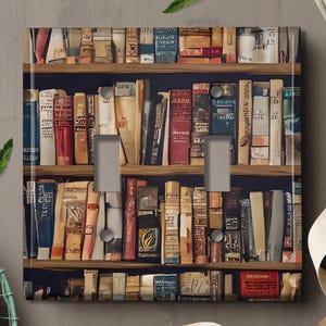 May include: A light switch cover with a bookshelf design featuring a variety of colorful books. The books are arranged on shelves with a dark wood finish. The switch cover is made of durable plastic and is easy to install.