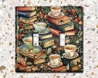 May include: A double light switch cover featuring a vintage illustration of a stack of books, teacups, and greenery. The design is in shades of green, brown, and cream.