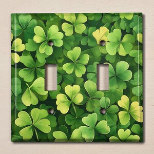 May include: A green and yellow light switch cover with a pattern of four-leaf clovers.