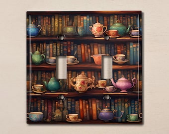 May include: A light switch cover featuring a bookshelf filled with books and teacups. The teacups are in various colours, including blue, green, pink, and white. The books are all different colours and sizes. The bookshelf is made of wood and has a dark brown finish.