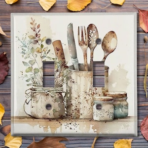 May include: A watercolor painting of kitchen utensils in jars and a metal container. The utensils include a knife, fork, and spoon. The jars and container are decorated with a floral pattern. The background is a light brown color.