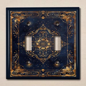 May include: A dark blue light switch cover with a gold ornate design featuring a mandala pattern and a starry night background.