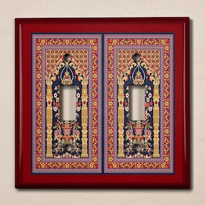 May include: A red light switch cover with a decorative design of a blue and gold patterned rug with a traditional archway motif.