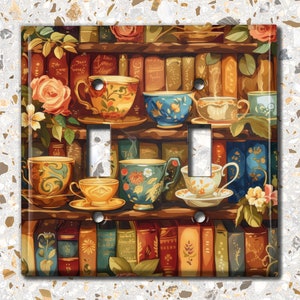 May include: A light switch cover featuring a vintage illustration of a bookshelf filled with books and teacups. The teacups are in various colors and patterns, including blue, green, and yellow. The bookshelf is made of wood and has a rustic look.