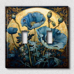 May include: A decorative double light switch cover featuring a floral design with blue poppies and green leaves against a gold and navy background. The artwork has an Art Nouveau style.
