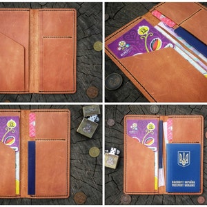 May include: A brown leather passport holder with multiple pockets for cards, cash, and a passport. The holder is open and shows a passport with the Ukrainian flag and the text "Паспорт України Passport Ukraine".