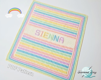May include: A crochet baby blanket with a rainbow stripe pattern and the name "SIENNA" in white yarn. The blanket has a yellow border and is on a white background.