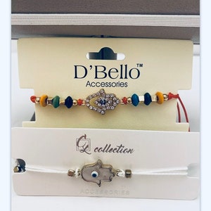 2 New Hamsa Hand and Evil Eye Bracelet Set. Condition is “New with tags”. One is red adjustable bracelet with glass beads and Hamsa in gold