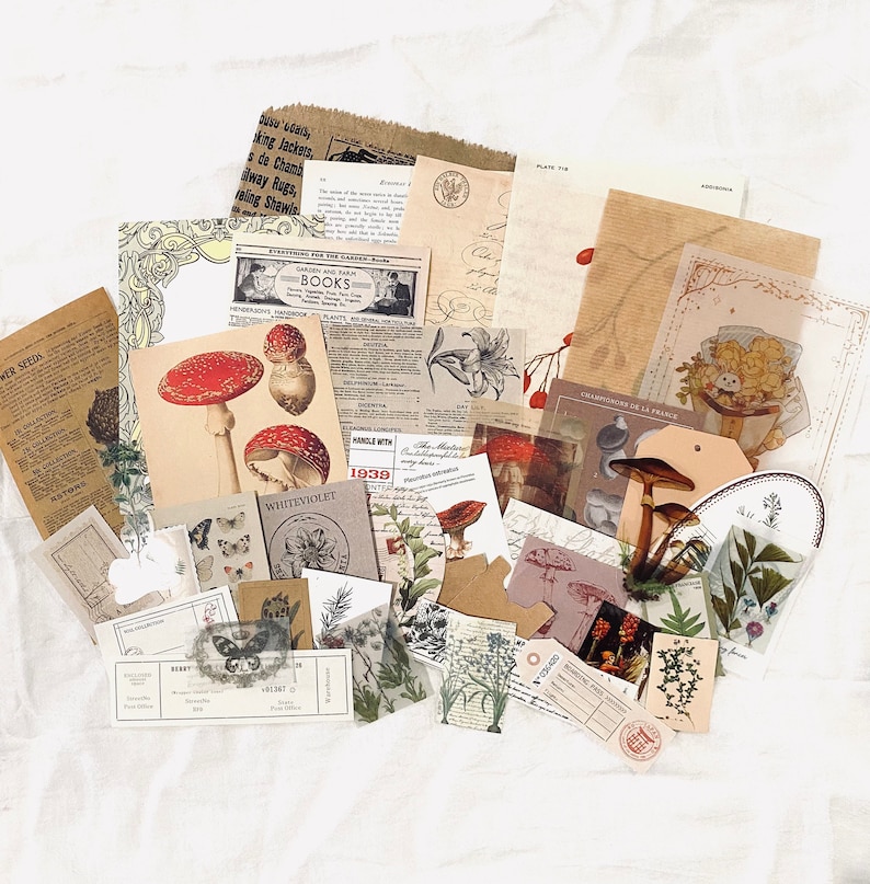 May include: A collection of vintage paper ephemera featuring mushrooms, flowers, and botanical illustrations. The papers are in various shades of brown, cream, and white, with some featuring text in French and English.