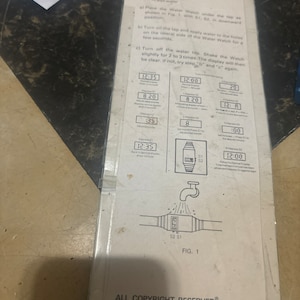 May include: A black and white instruction sheet for a water watch. The instructions show how to set the time and date on the watch. The watch has a black and white display with a white background and black numbers. The watch is shown in a diagram with water flowing over it.