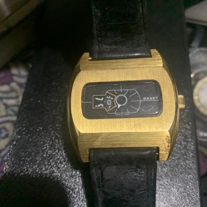 Ganet swiss made deluxe direct read gold and black jump hour windup watch from 1970s