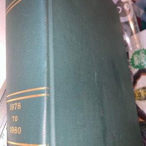 May include: A teal-colored book spine with gold lettering and accents. The text "1978 TO 1980" is visible. The book has a textured cover.